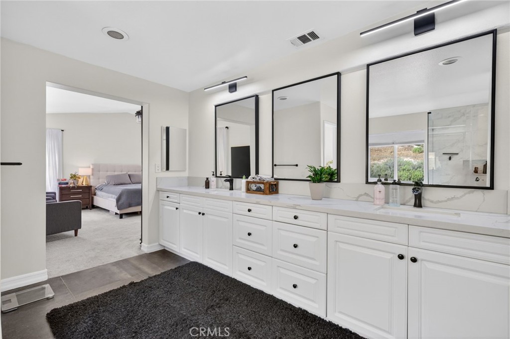 45136 Willowick Street Temecula, CA 92592 - Photo 50 of 75 a spacious bathroom with double sink and a mirror