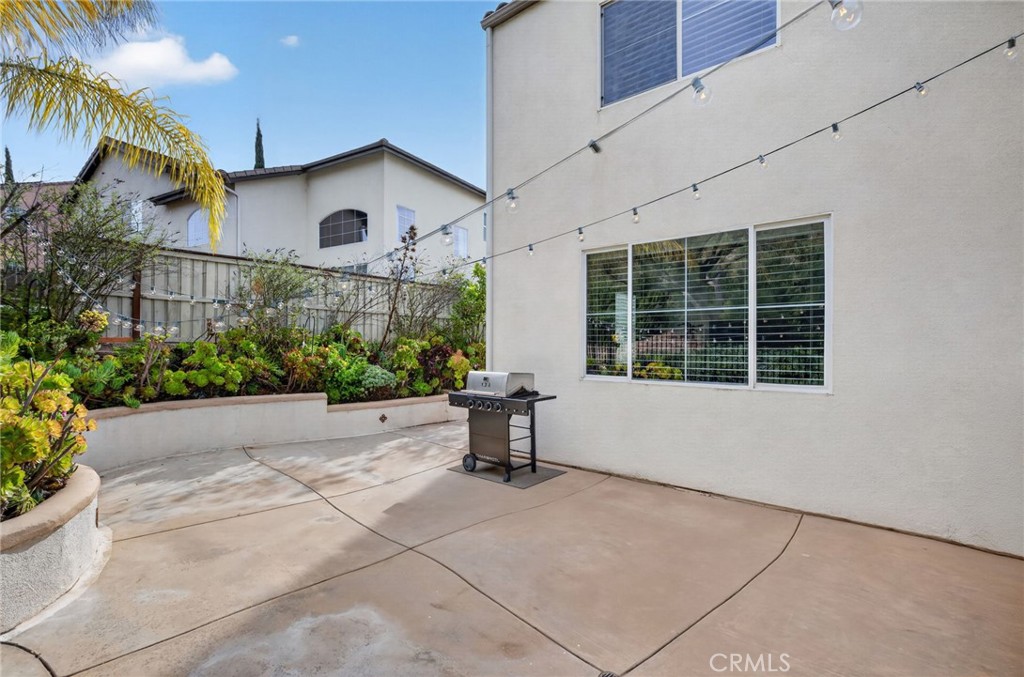 45136 Willowick Street Temecula, CA 92592 - Photo 56 of 75 a white house with a flower garden in front of it