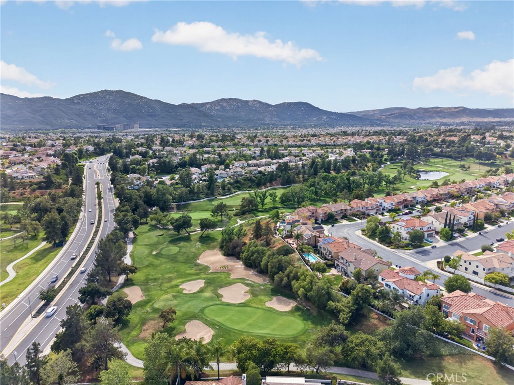 45136 Willowick Street Temecula, CA 92592 - Photo 61 of 75 an aerial view of green landscape with trees houses and mountain view