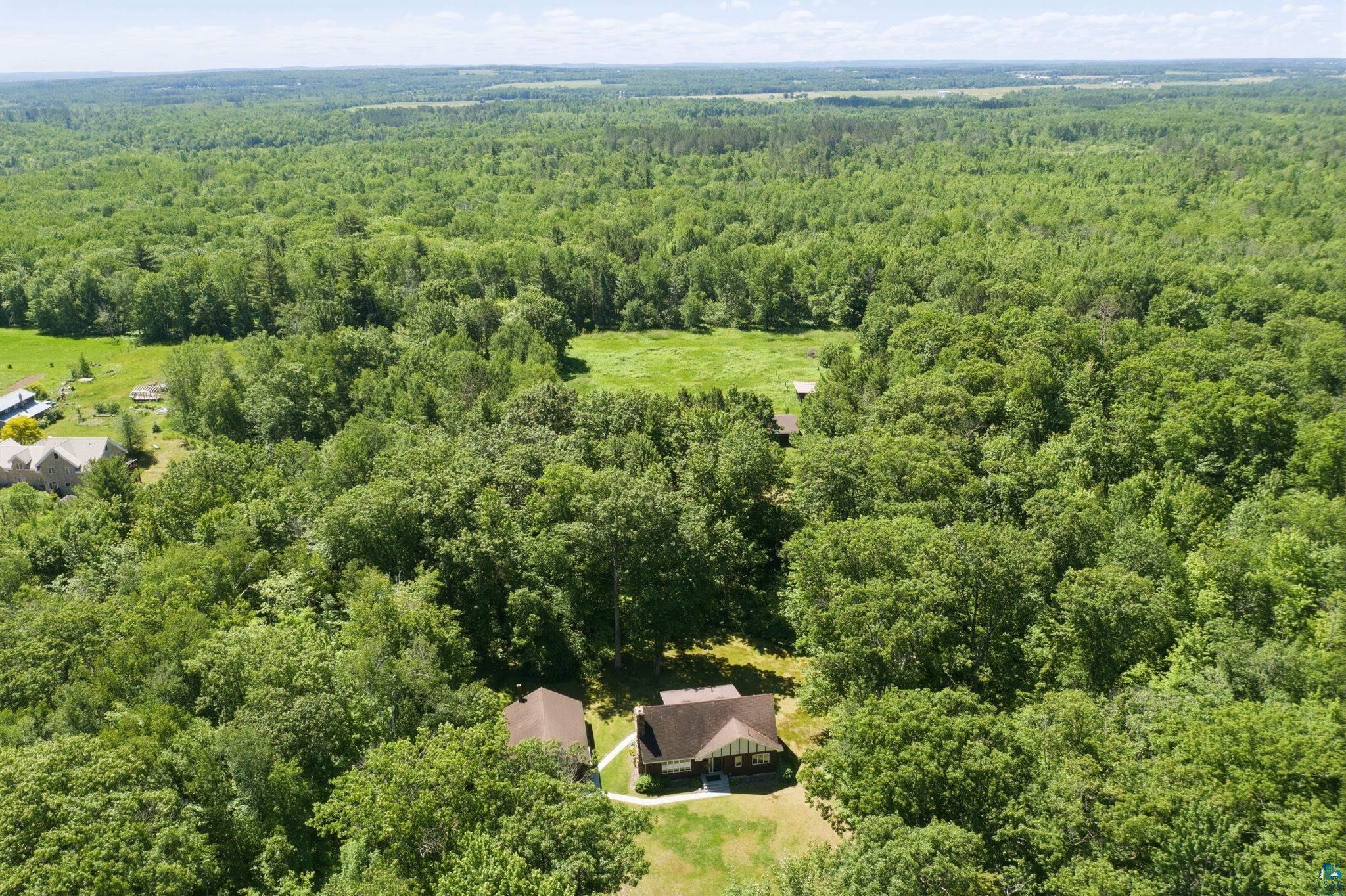 27485 South Kane Road Ashland, WI 54806 - Photo 31 of 35 Expansive wooded acreage featuring a single-story residence with a brown roof and a second structure