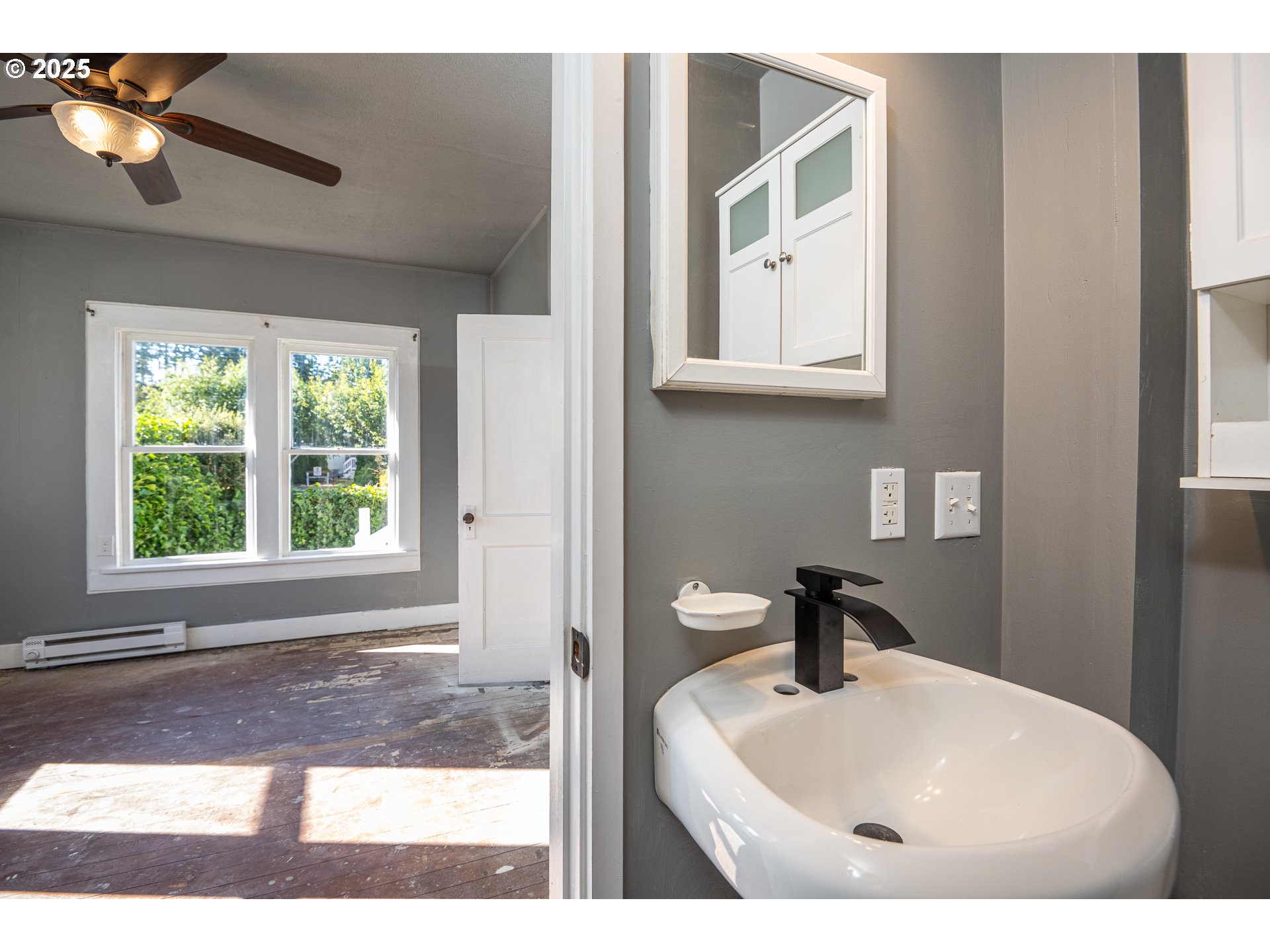 289 Harbor Street Florence, OR 97439 - Photo 17 of 47 a bathroom with a sink a mirror and a window