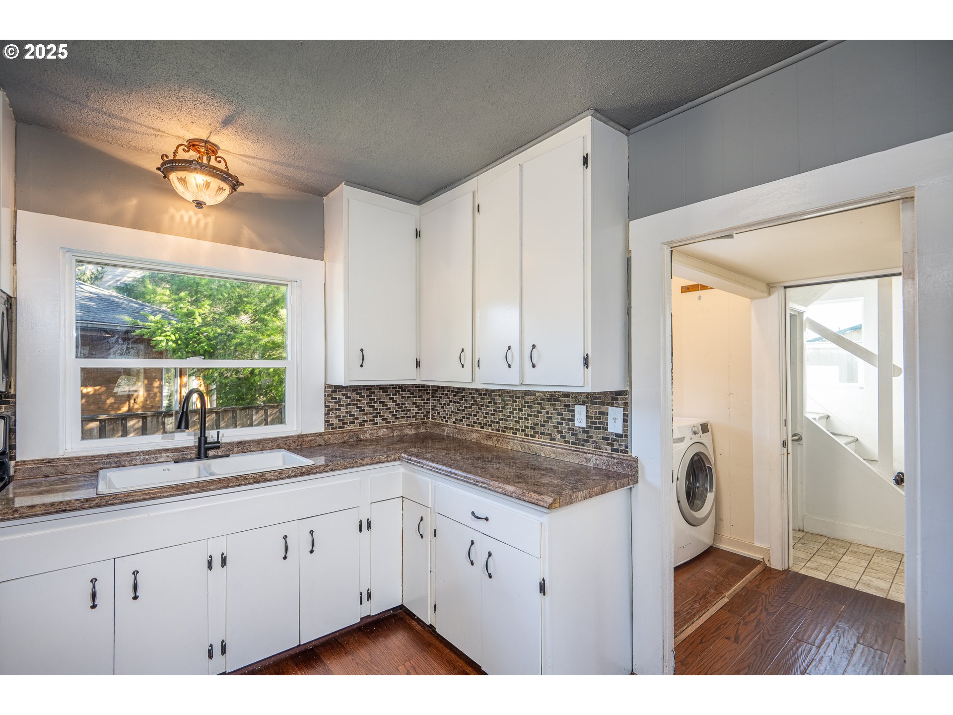 289 Harbor Street Florence, OR 97439 - Photo 25 of 47 a kitchen with granite countertop white cabinets and a large window