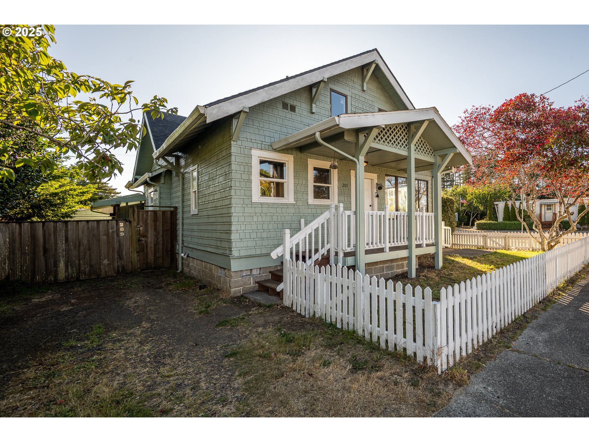 289 Harbor Street Florence, OR 97439 - Photo 5 of 47 a view of a house with a small yard and wooden fence