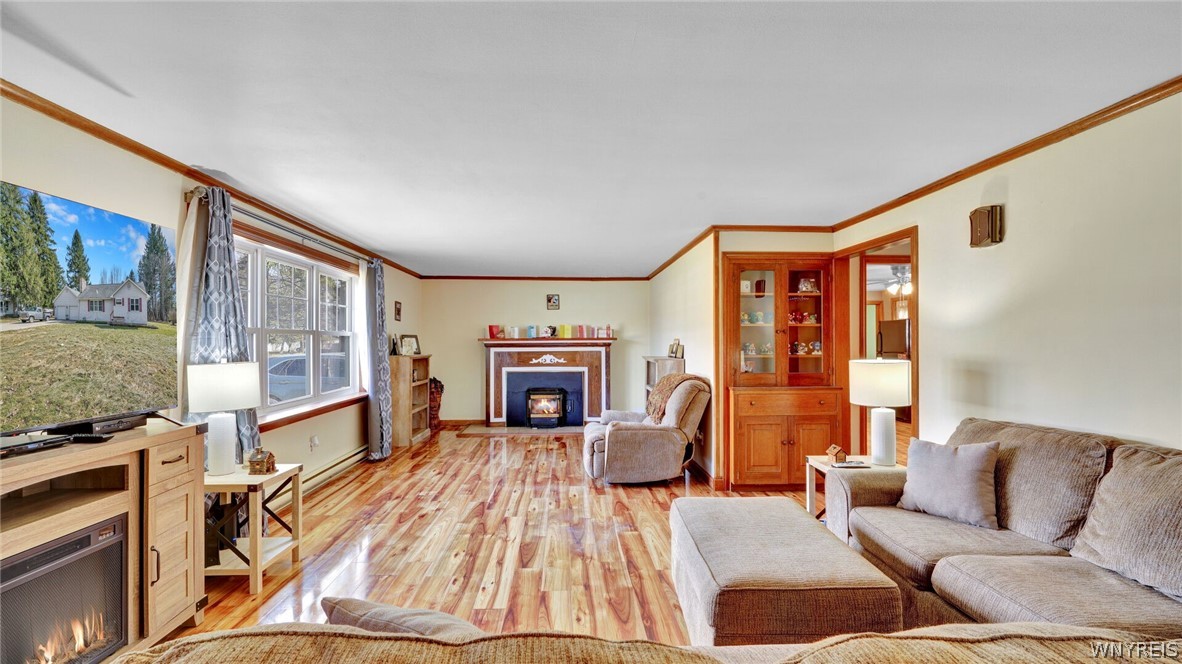 336 Highway 39 Arcade, NY 14009 - Photo 4 of 28 Oversized living room has FP with pellet insert.