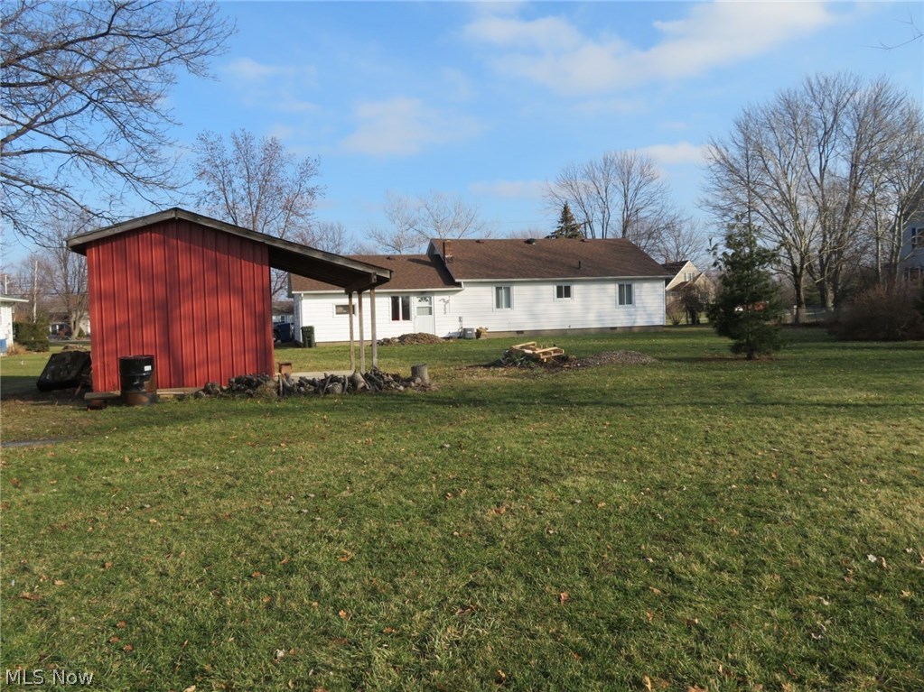 8965 Bender Road North Ridgeville, OH 44039 - Photo 2 of 19 View of the back side of the house & yard. Sits on .59 acres (128 x 222). As a FYI, the pile of dirt closest to the house will be leveled out, was just extra dirt offered to the seller.