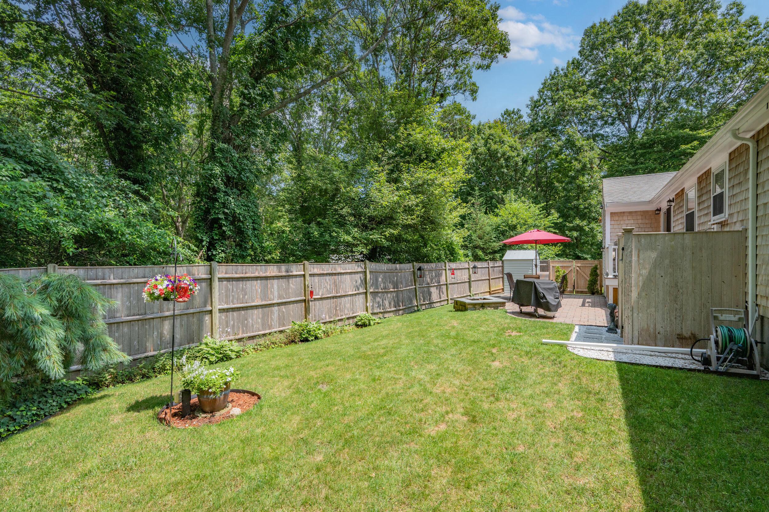 19 Shagbark Road Forestdale, MA 02644 - Photo 3 of 44 a backyard of a house with table and chairs