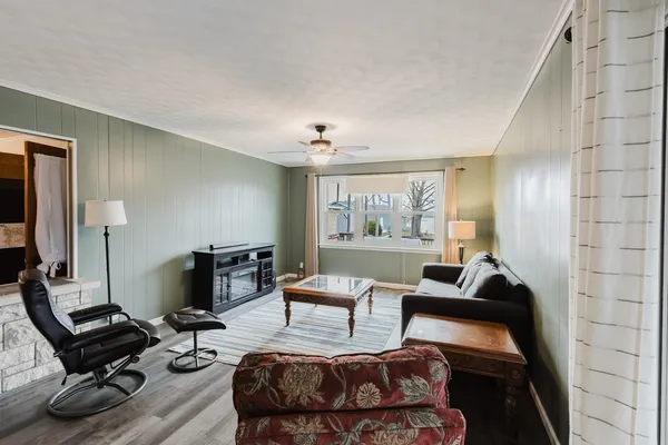 a living room with furniture rug and window
