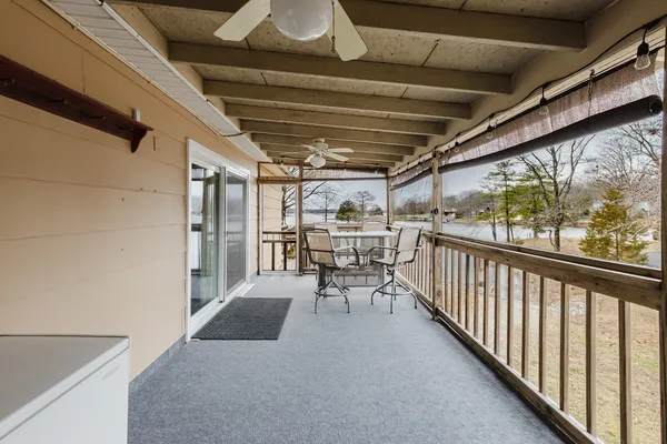 a view of a porch with table and chairs