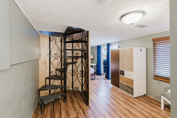 a view of a hallway with wooden floor
