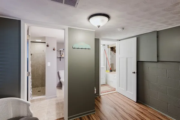 a bedroom with a bed and wooden floor