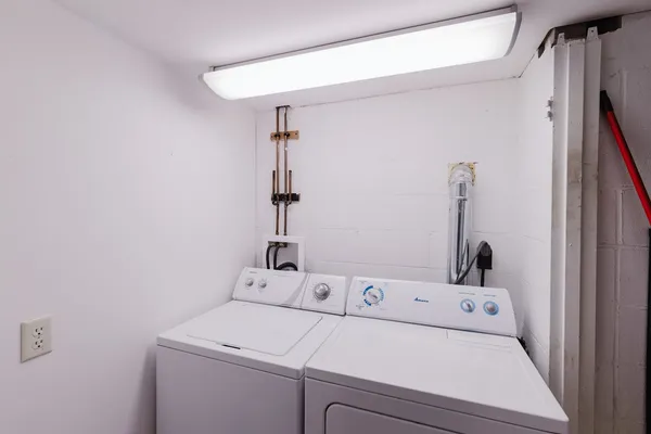 a view of a roof deck with couches and wooden fence