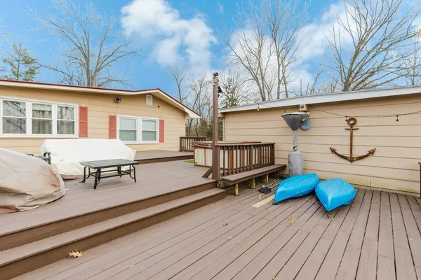 a view of a deck with chairs and wooden fence