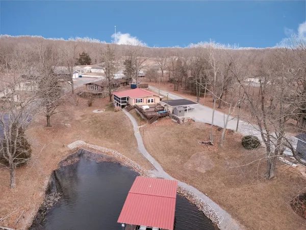 a view of a house with a yard and deck