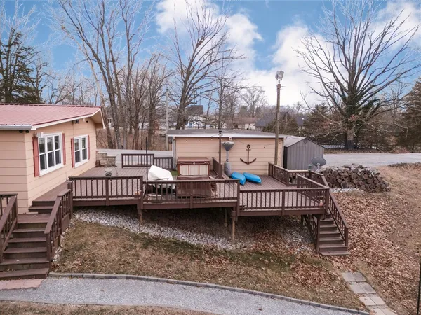 a backyard of a house with barbeque oven