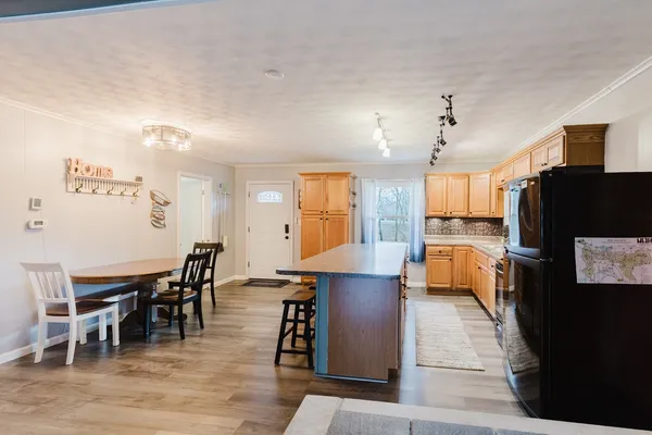 a kitchen with stainless steel appliances granite countertop a stove and a wooden cabinets