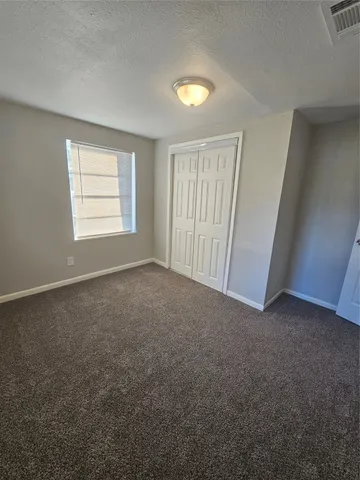 an empty room with a empty space and windows