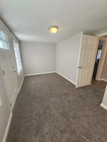 an empty room with windows and entrance