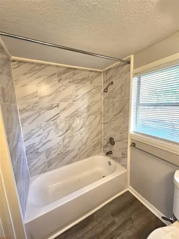 a bathroom with a shower and a bathtub