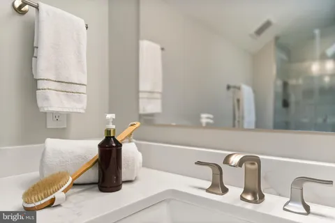 a white toilet sitting next to a bathroom sink