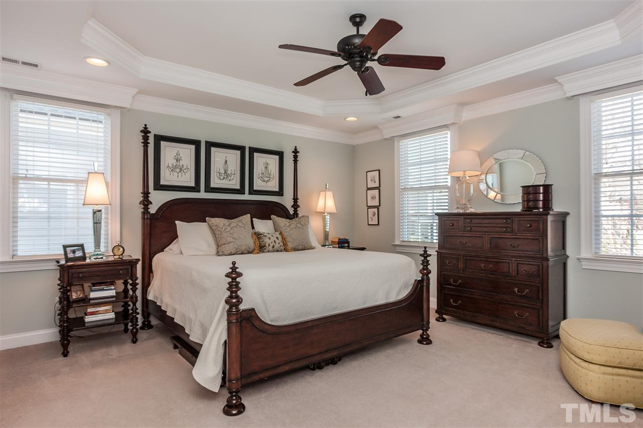3105 Raymond Street Raleigh, NC 27607 - Photo 14 of 22 a spacious bedroom with a bed a dresser and a chandelier