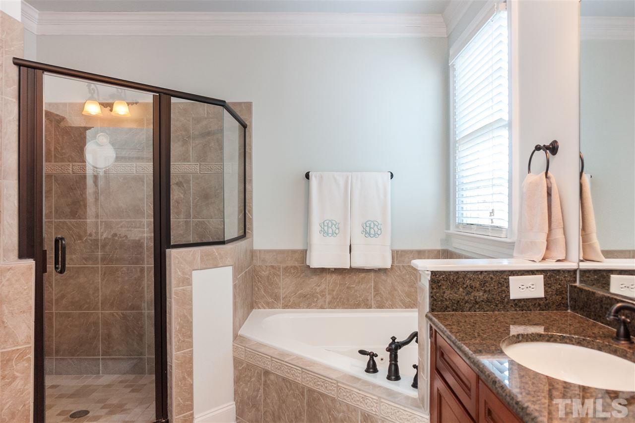 3105 Raymond Street Raleigh, NC 27607 - Photo 16 of 22 a bathroom with a granite countertop tub sink and mirror