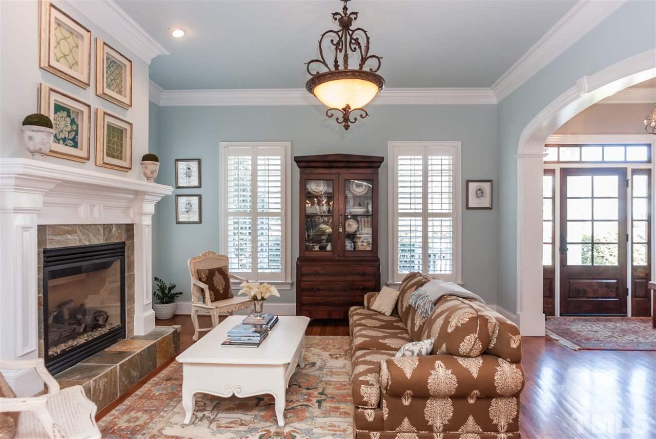 3105 Raymond Street Raleigh, NC 27607 - Photo 4 of 22 a living room with furniture chandelier and a fireplace