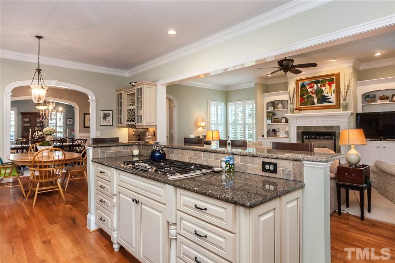 3105 Raymond Street Raleigh, NC 27607 - Photo 10 of 22 a kitchen with a stove cabinets and wooden floor
