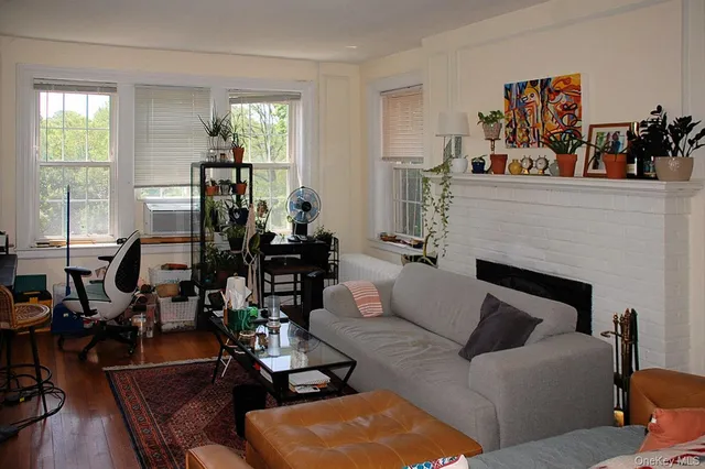 a living room with furniture fireplace and window