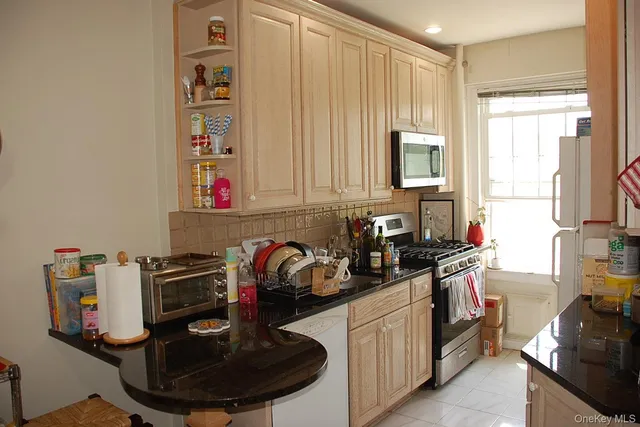 a kitchen with a sink appliances and cabinets