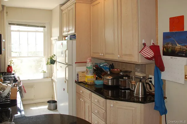 a kitchen with refrigerator and window
