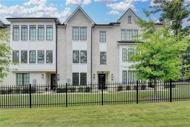 a front view of a house with a garden and plants