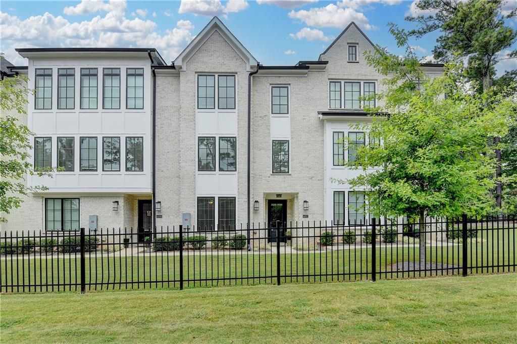 a front view of a house with a garden and plants