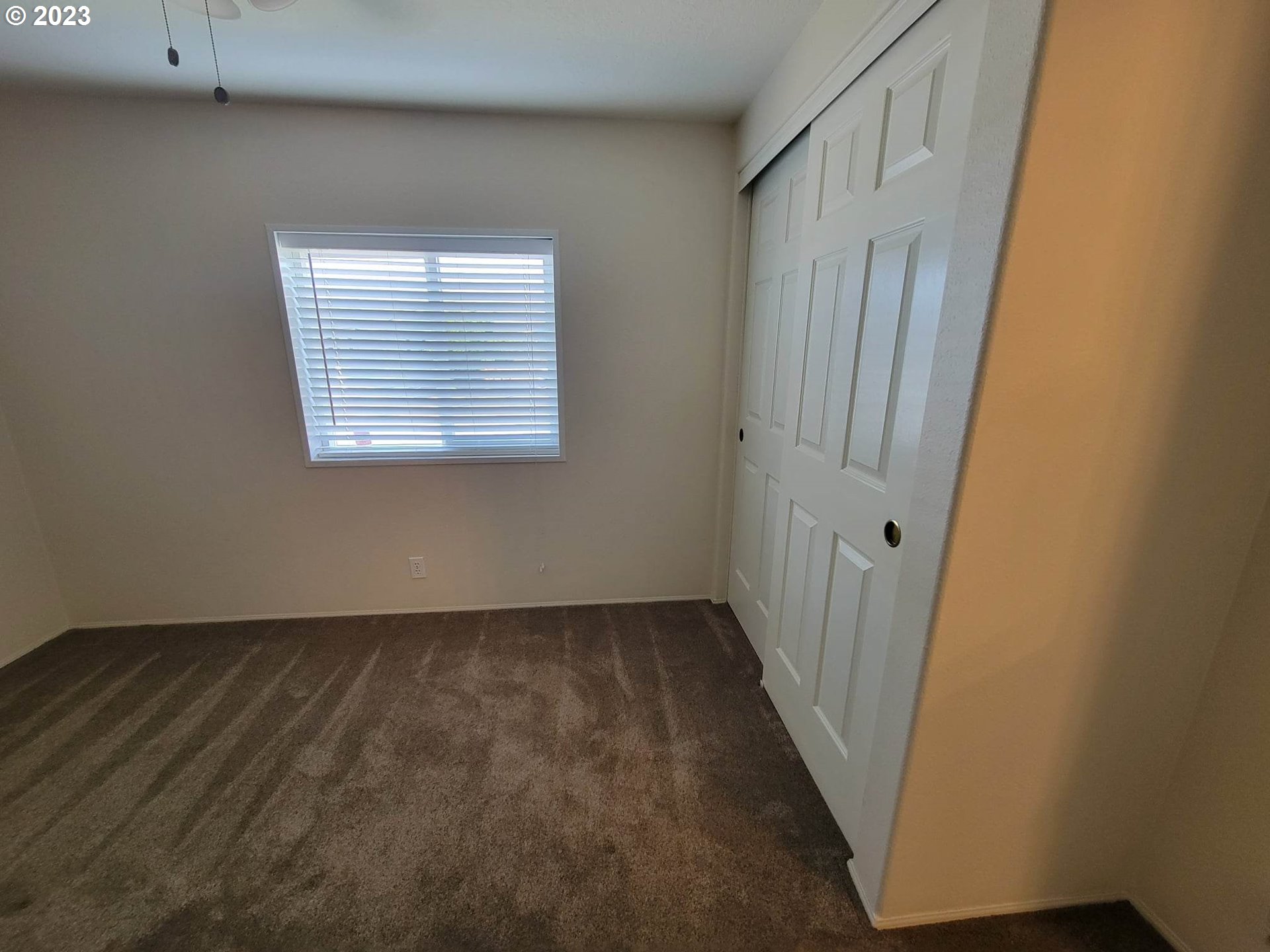 1315 Settlers Loop Forest Grove, OR 97116 - Photo 23 of 37 a view of an empty room with wooden floor and a window