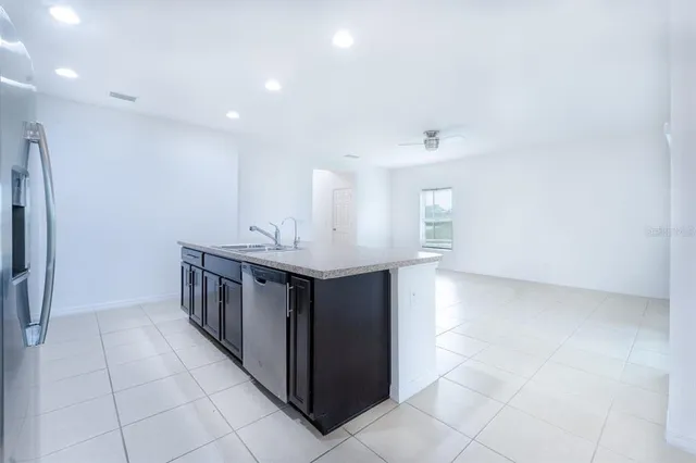 a kitchen with stainless steel appliances a sink and a refrigerator