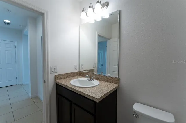 a sink and a mirror with vanity