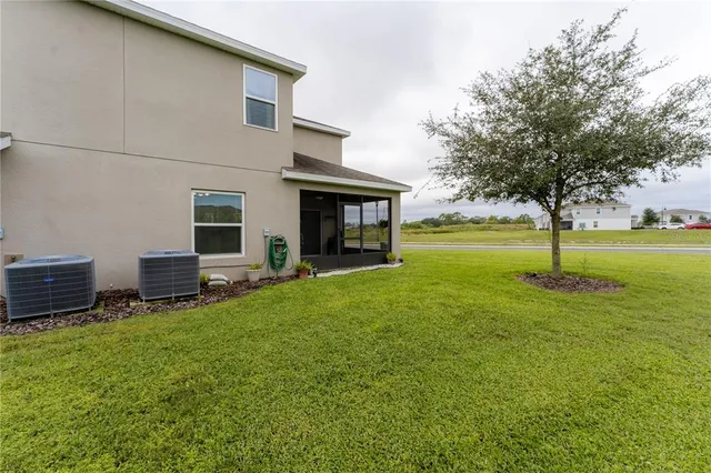 a view of a house with a yard and sitting area