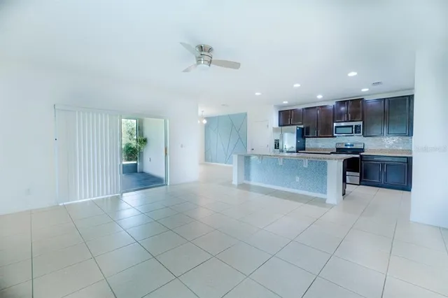 a view of kitchen with kitchen island and stainless steel appliances