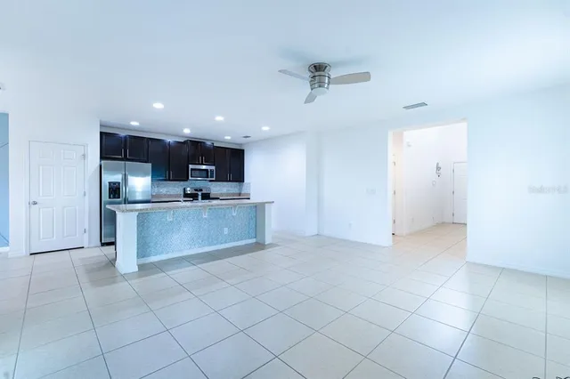 a kitchen with stainless steel appliances granite countertop a refrigerator and a sink