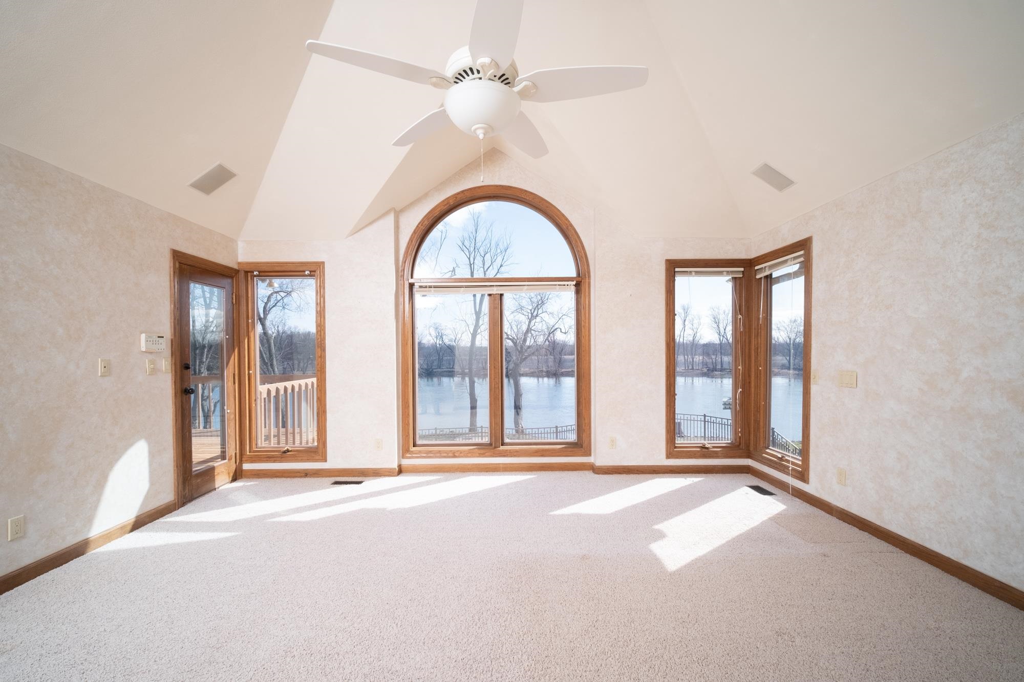 9805 Rivers Bend Drive Roscoe, IL 61073 - Photo 19 of 49 an empty room with windows and ceiling fan
