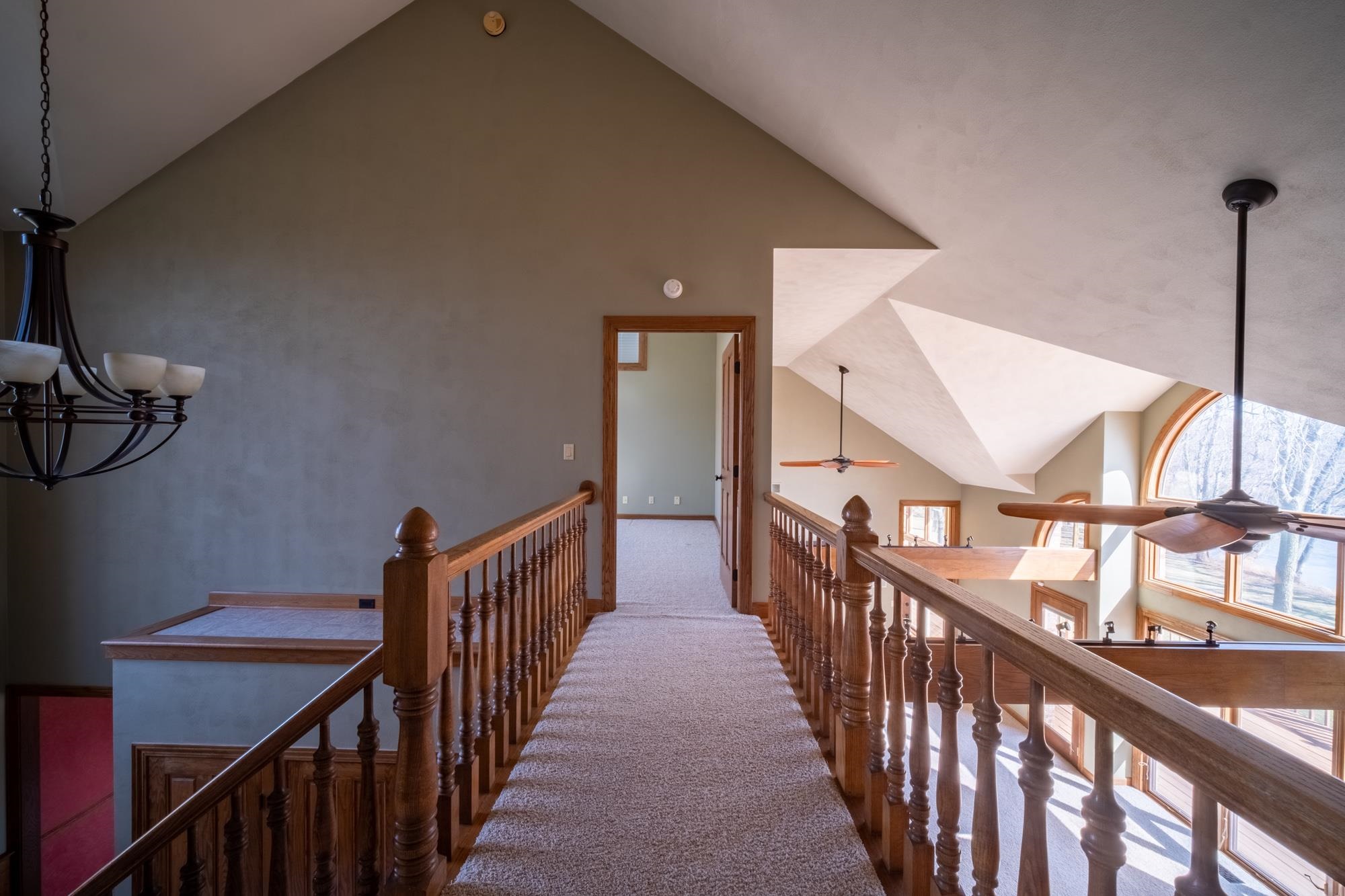 9805 Rivers Bend Drive Roscoe, IL 61073 - Photo 29 of 49 a view of staircase with railing and a chandelier