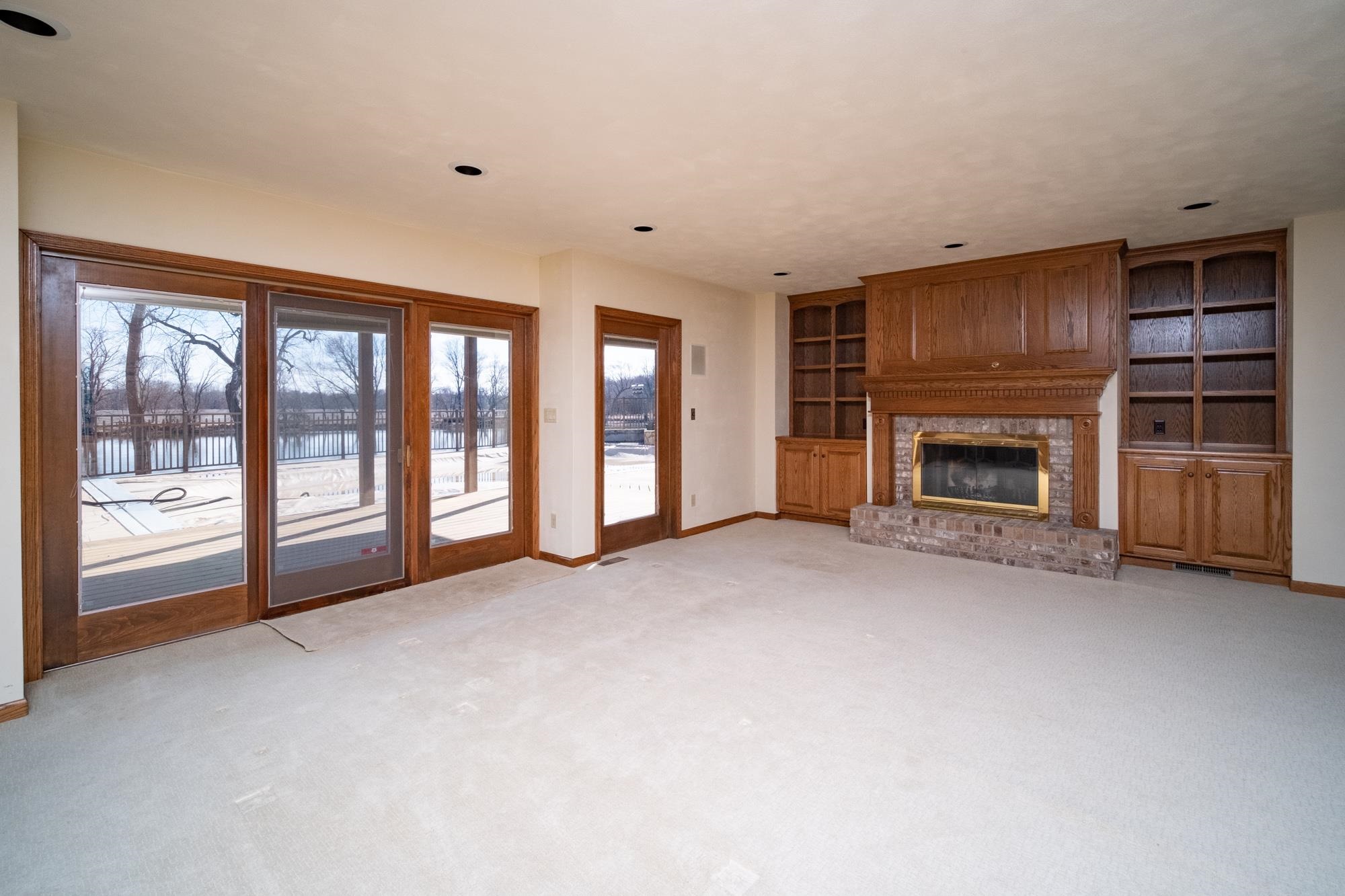 9805 Rivers Bend Drive Roscoe, IL 61073 - Photo 34 of 49 a view of an empty room with a fireplace and a window