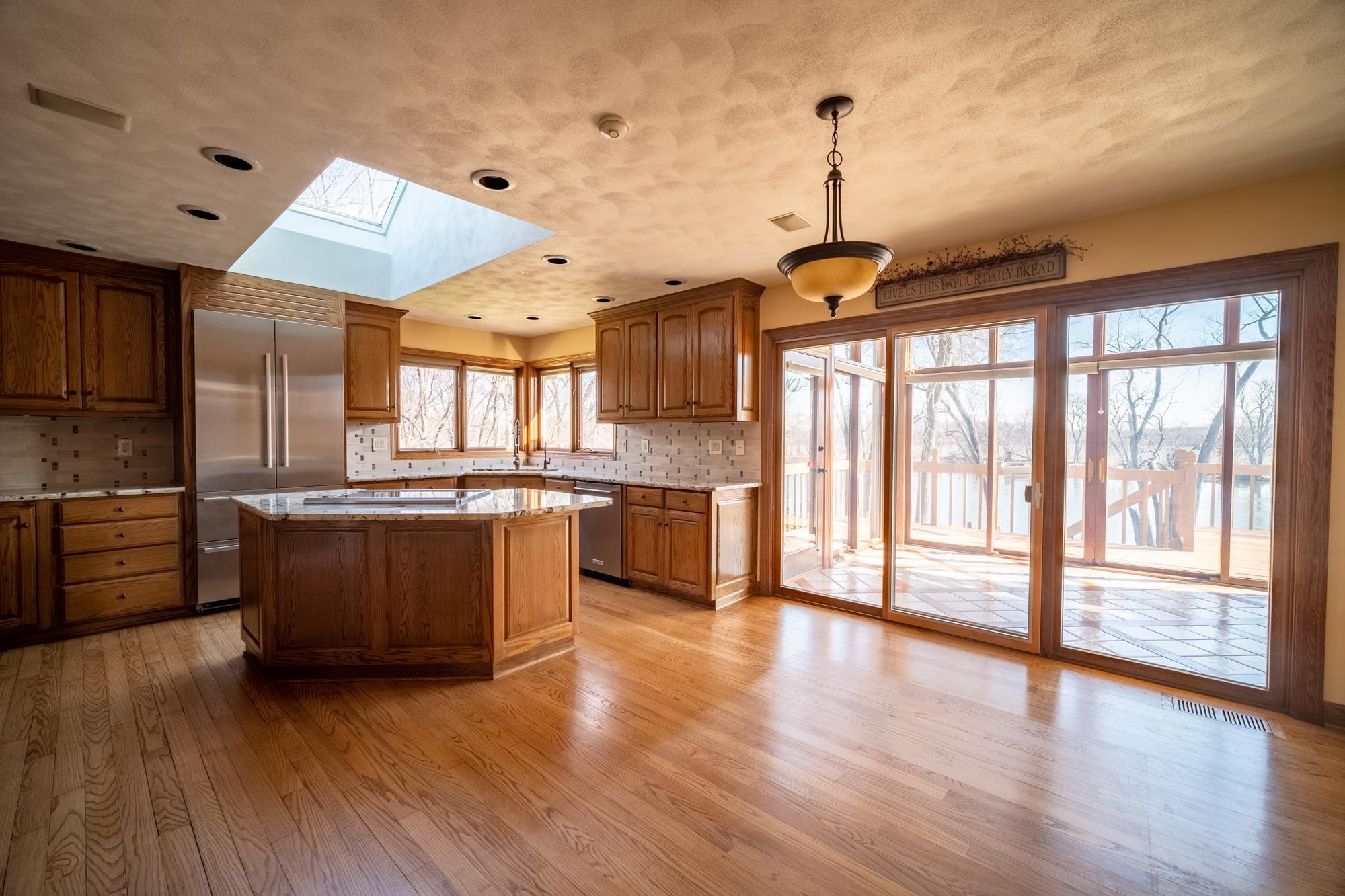 9805 Rivers Bend Drive Roscoe, IL 61073 - Photo 9 of 49 a kitchen with stainless steel appliances granite countertop a stove and wooden floor