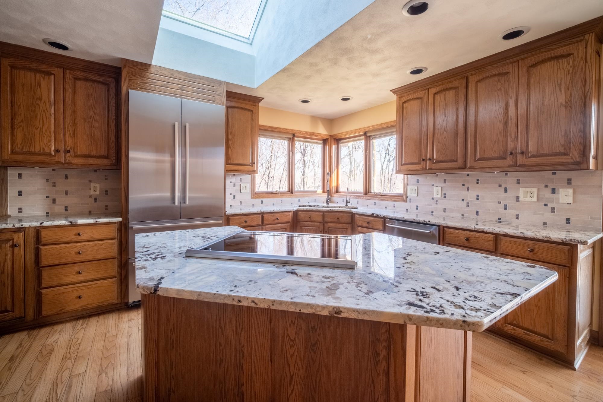 9805 Rivers Bend Drive Roscoe, IL 61073 - Photo 10 of 49 a kitchen with granite countertop wooden cabinets a sink and dishwasher