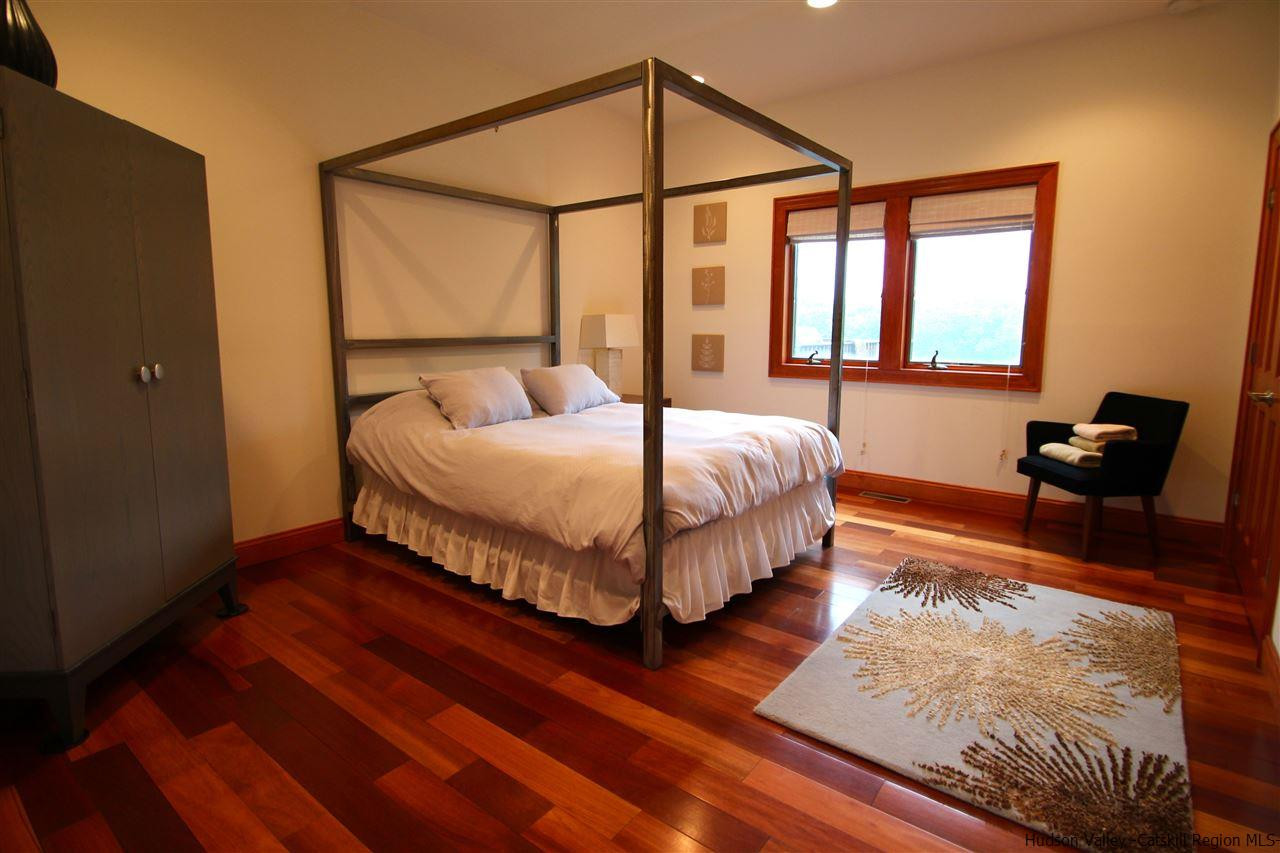 90 High Rocks Road Glenford, NY 12433 - Photo 15 of 34 a bedroom with a bed and wooden floor