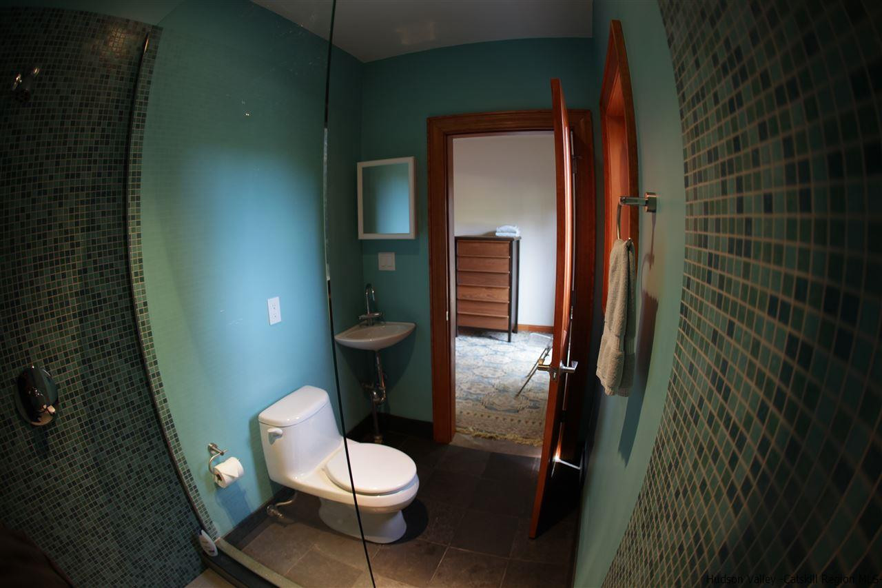 90 High Rocks Road Glenford, NY 12433 - Photo 33 of 34 a white toilet sitting next to a bathroom sink and a shower