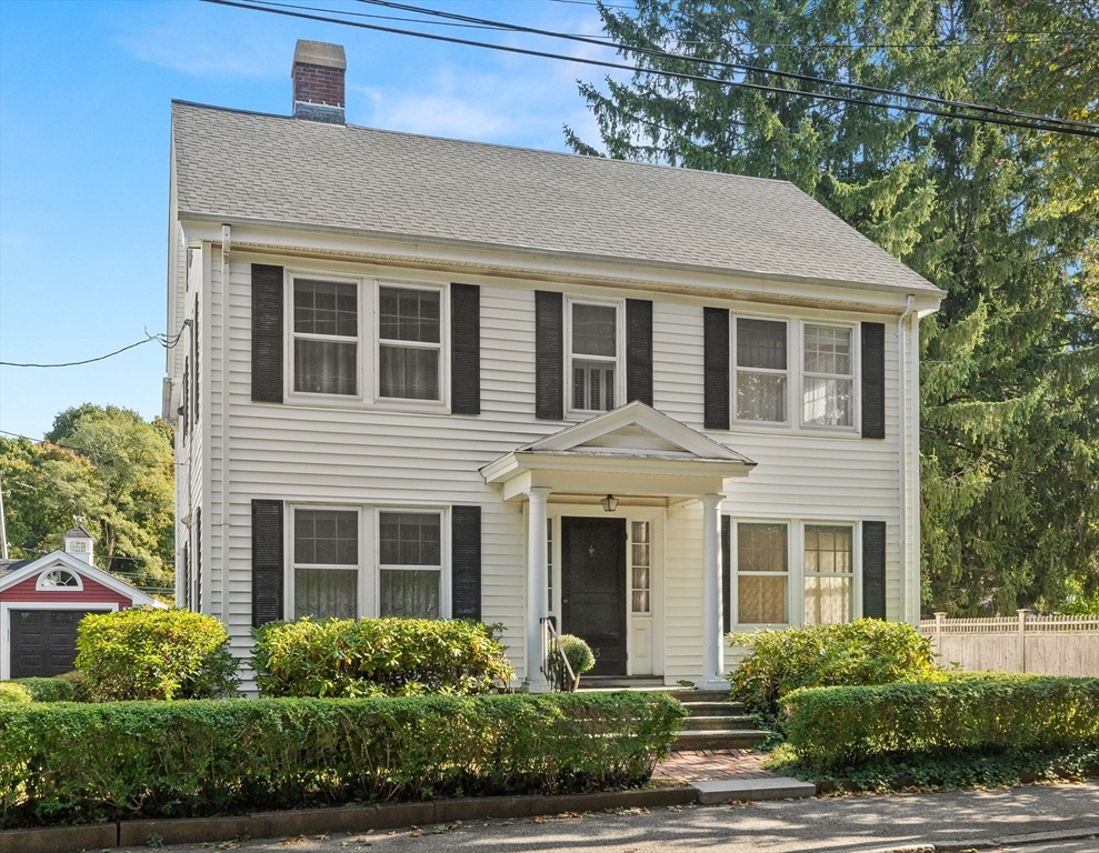 25 High Street Beverly, MA 01915 - Photo 1 of 42 a front view of a house with garden and garage