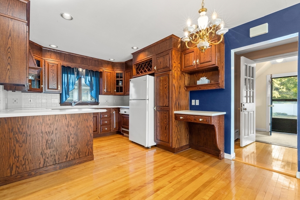 25 High Street Beverly, MA 01915 - Photo 12 of 42 a kitchen with stainless steel appliances granite countertop a refrigerator a oven and a sink with granite countertops