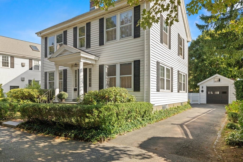 25 High Street Beverly, MA 01915 - Photo 2 of 42 a front view of a house with a garden