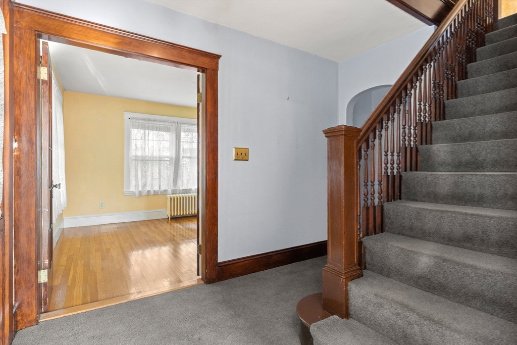 25 High Street Beverly, MA 01915 - Photo 21 of 42 a view of an entryway with wooden floor and door