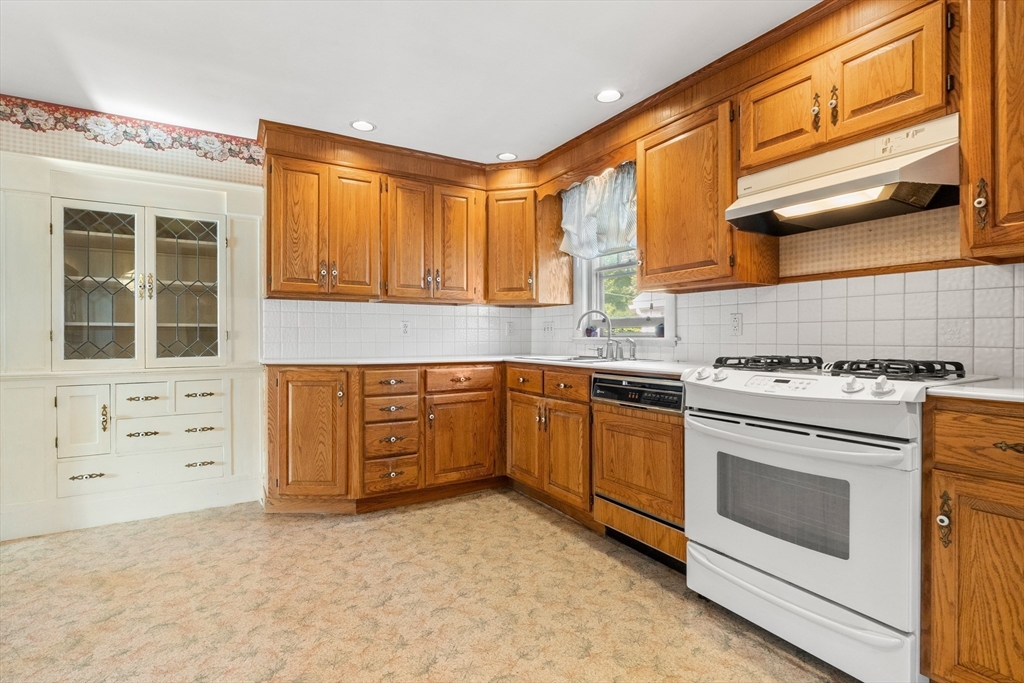25 High Street Beverly, MA 01915 - Photo 23 of 42 a kitchen with white cabinets and white appliances